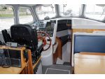 The conning position in MM. Note the traditional ship’s wheel.